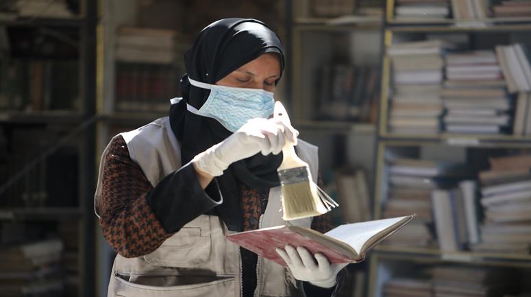 متطوعون يرممون كتبا تضررت جراء القصف الإسرائيلي في مكتبة الجامع العمري الكبير بمدينة غزة