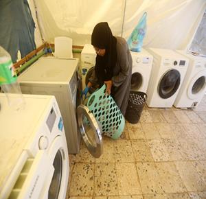 مواطنون يغسلون الملابس باستخدام غسالات كهربائية في مخيم للنازحين غرب مدينة غزة، وسط صعوبات في توفير المياه والكهرباء اللازمة لتشغيلها، فيما تواجه النساء تحديات متزايدة في أداء المهام المنزلية بسبب غياب المساحات الملائمة والخدمات الأساسية