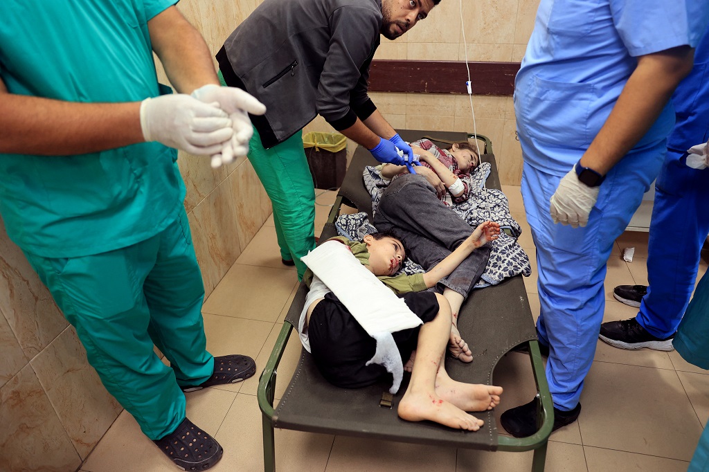 طفلان أصيبا في غارة إسرائيلية، يتلقيان العلاج في مستشفى "شهداء الأقصى" في مدينة دير البلح وسط قطاع غزة (تصوير: أ ف ب)