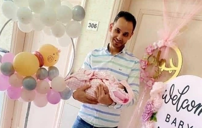 الشهيد رواجبه يحمل طفلته جوان